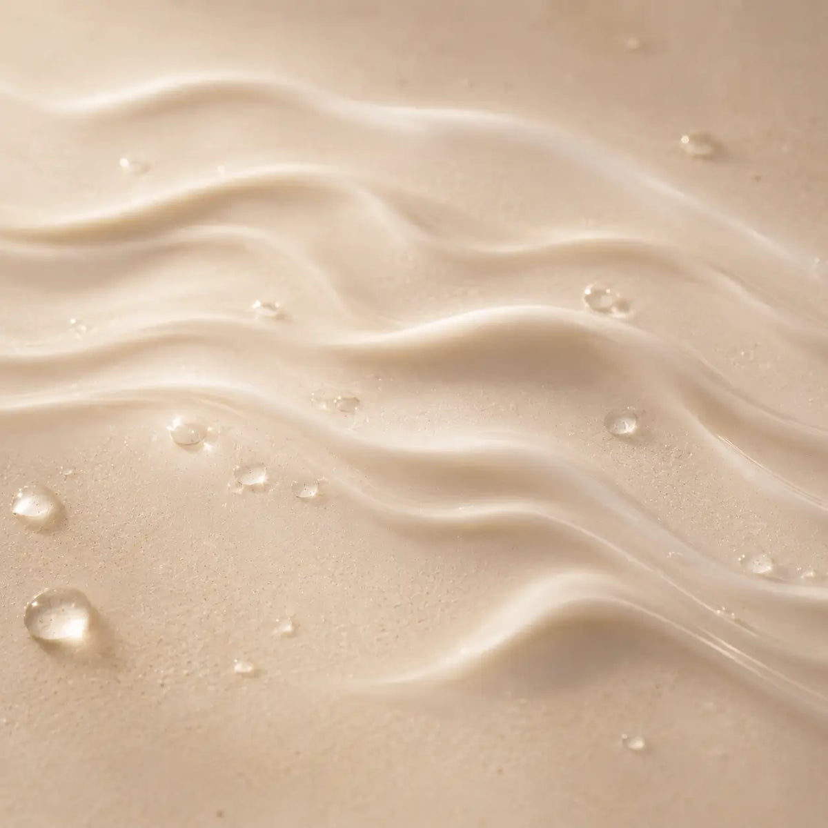 Artistic macro photograph of a silky skincare texture symbolizing prebiotics and a balanced skin barrier.