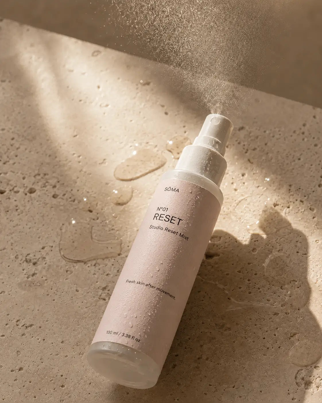 SÖMA No. 01 Reset Studio Mist hydrating facial mist with prebiotics, hyaluronic acid and sodium PCA on natural travertine stone.